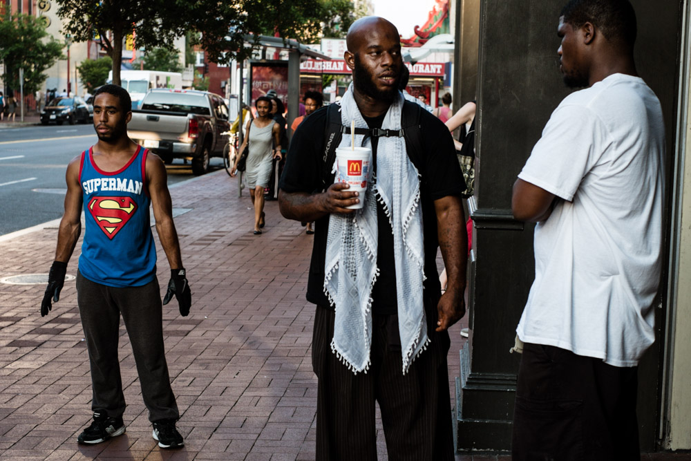 A street dancer awaits his cue in Chinatown. Washington D.C, USA.