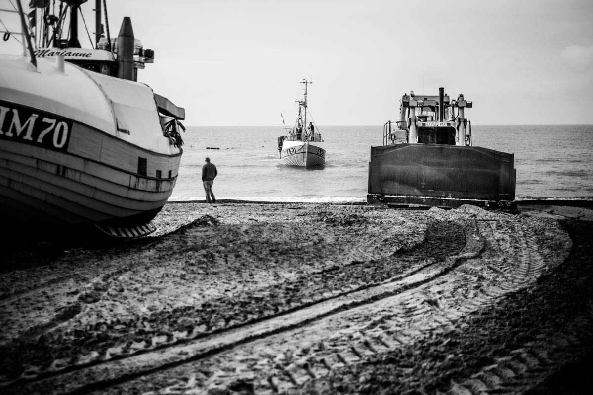 The fishing boats from Thorup are hauled up to the beach by a big ol' Caterpillar