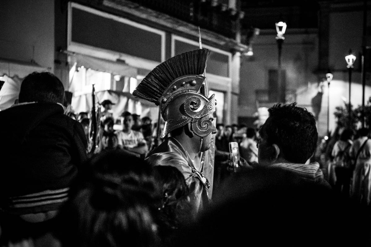 A Roman soldier keeps the crowd at bay, making room for the Procession of Silence on the main road.