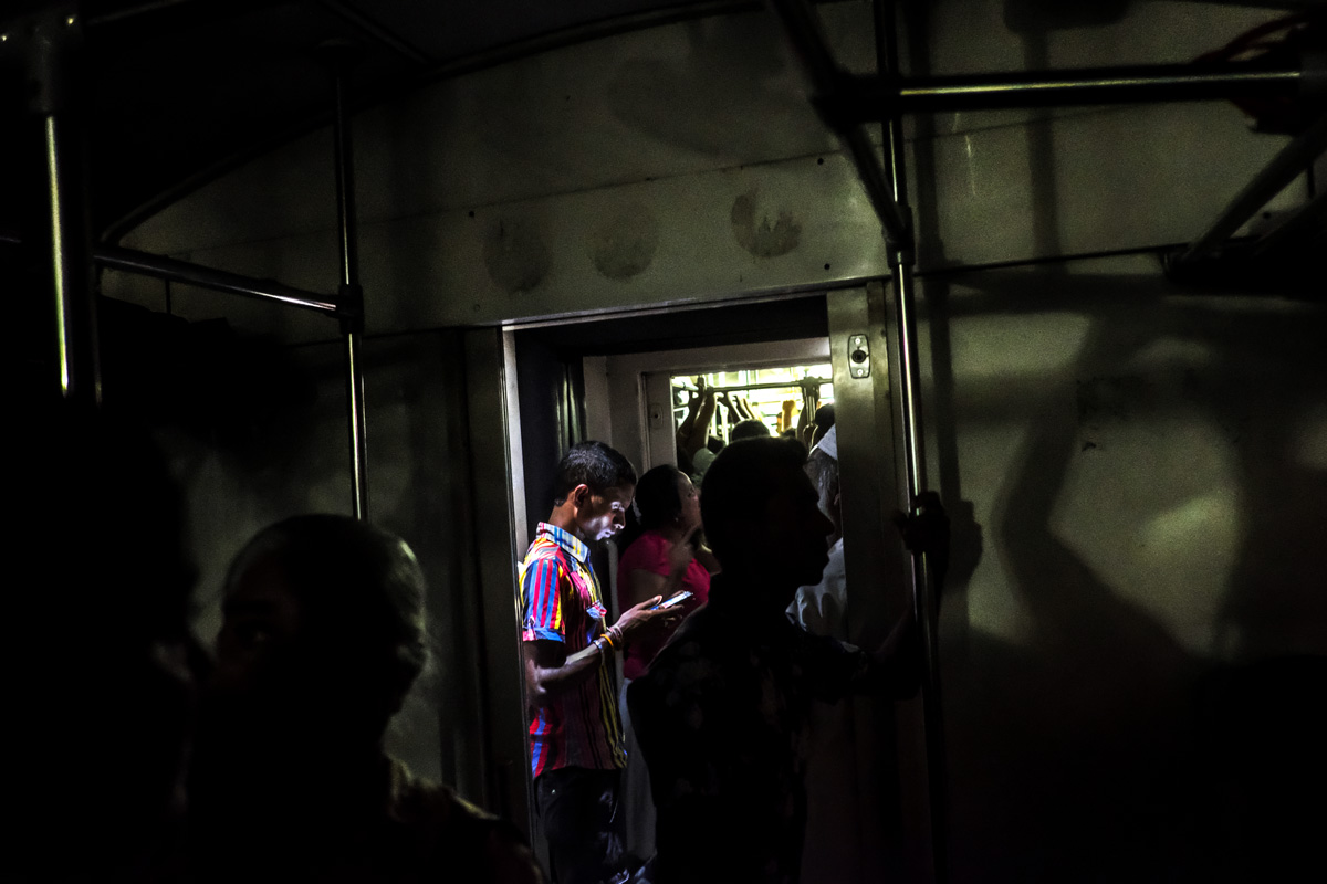 Passenger on the train. Colombo, Sri Lanka -- Fuji X-Pro 2, XF 18mm F2 | 1/19 sec, f2, ISO 10,000