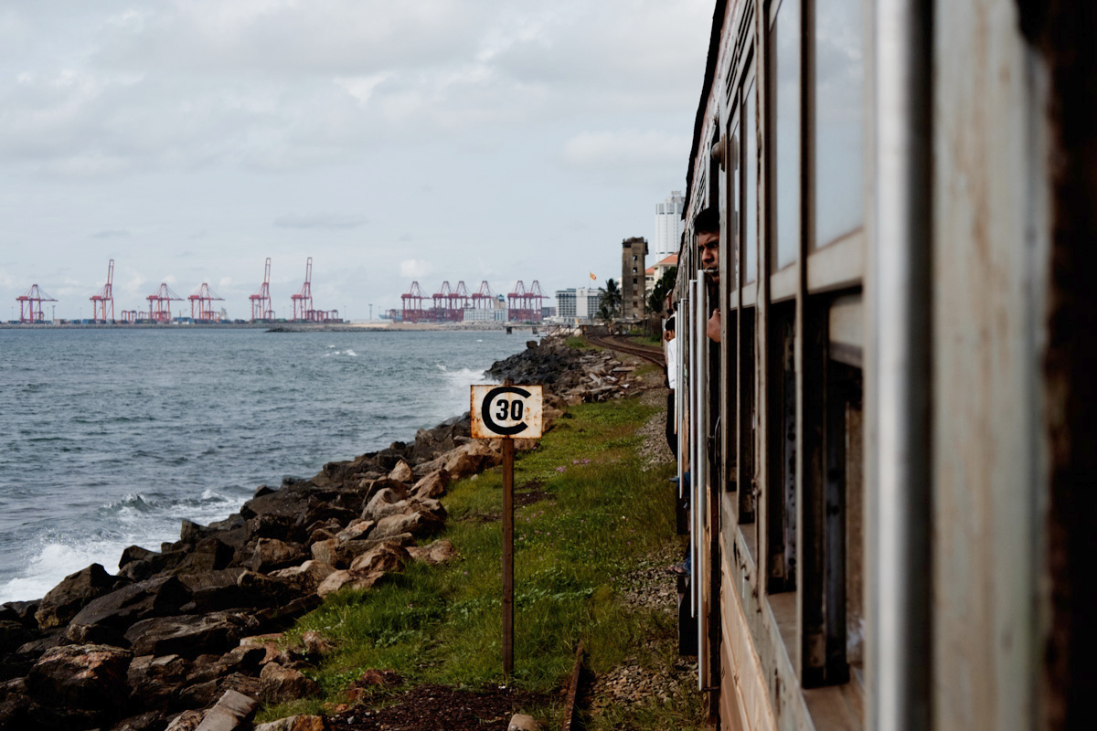 Hanging out the side of a commuter train as it makes its way into the city, trying not to lose my camera... or my grip.