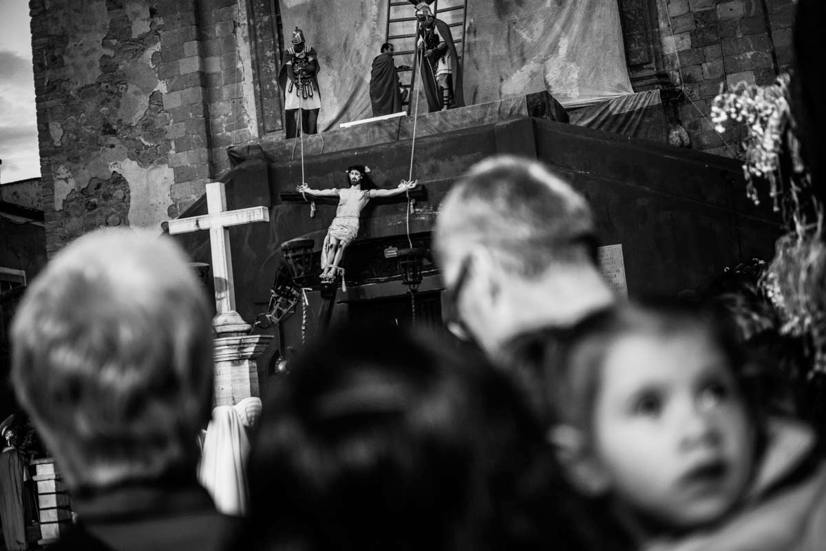 Bystanders, local and foreign alike, watch the reenactment of the crucifixion in Plaza de San Roque